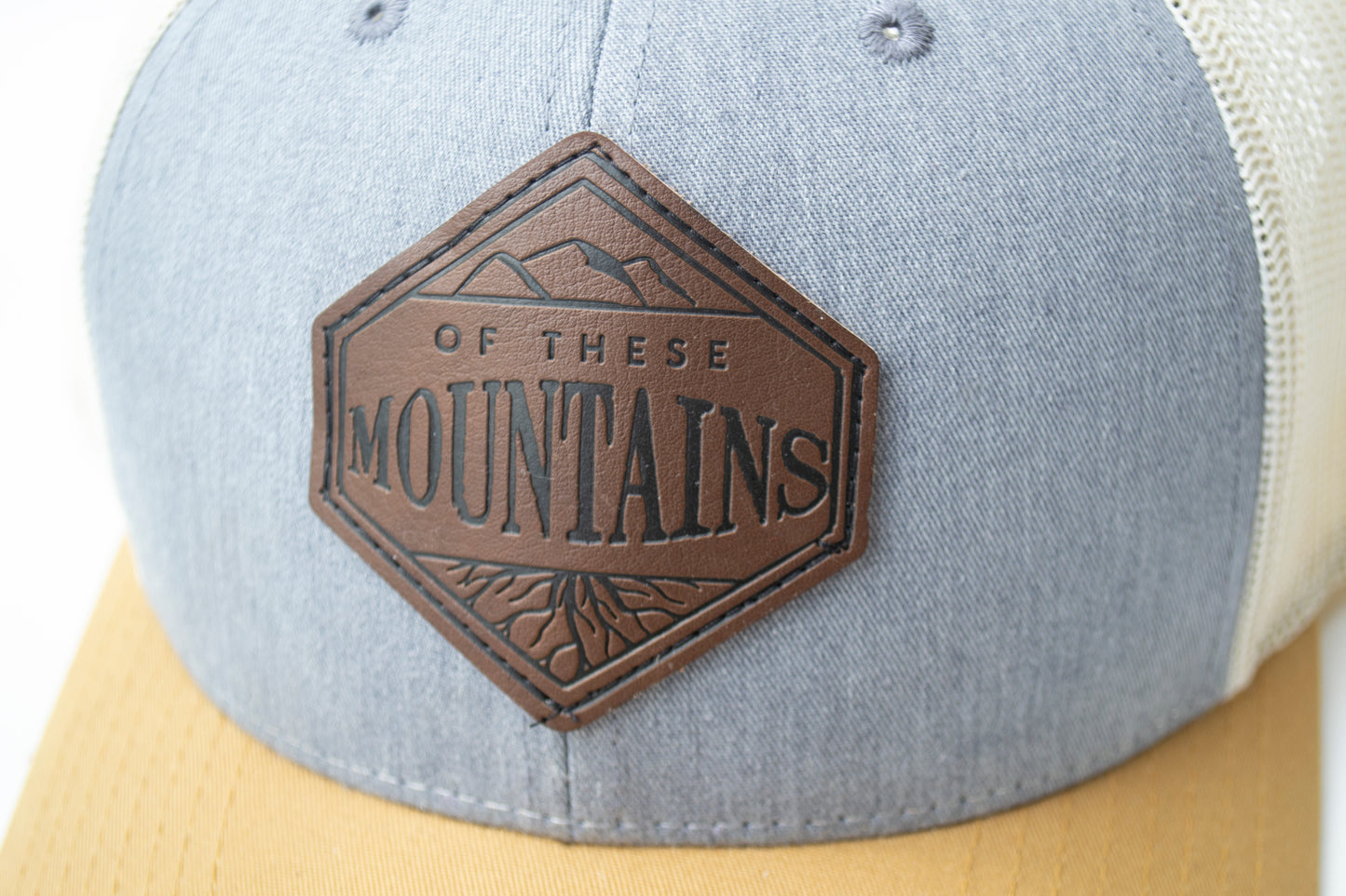 Of These Mountains Loving Leather Patch Trucker Hat